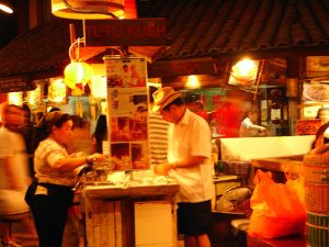 Kueh_tutu_seller_at_a_Food_Republic_food_court_in_Singapore-2-300x225.jpg