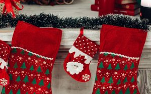 three-red-and-green-christmas-stocking-mounted-on-wall-1734424-300x186.jpg
