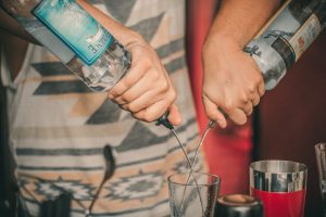 person-holding-two-soda-bottles-with-drinking-glass-below-681846-300x200.jpg