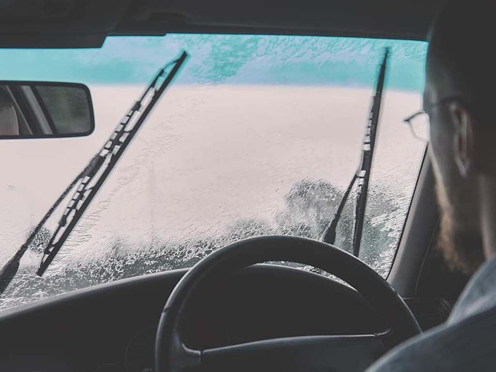 resizecar-windshield-driving-raining-windshield-wipers-guy-man-people-steering-wheel.jpg.optimal.jpg