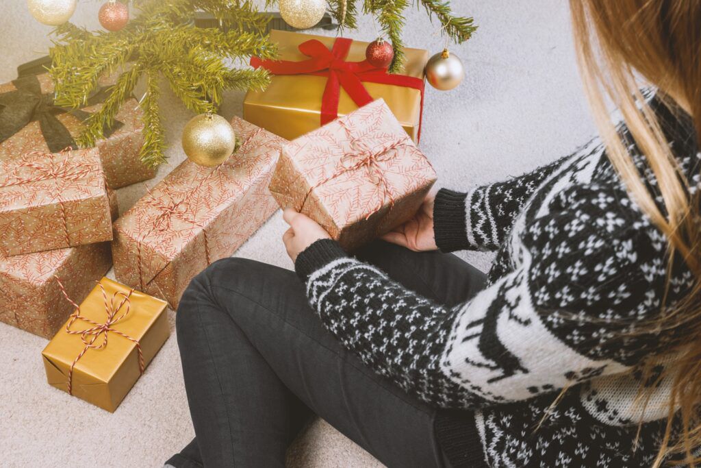woman-in-sweatshirt-and-jeans-holding-a-gift-box-714695-1024x683.jpg.optimal.jpg